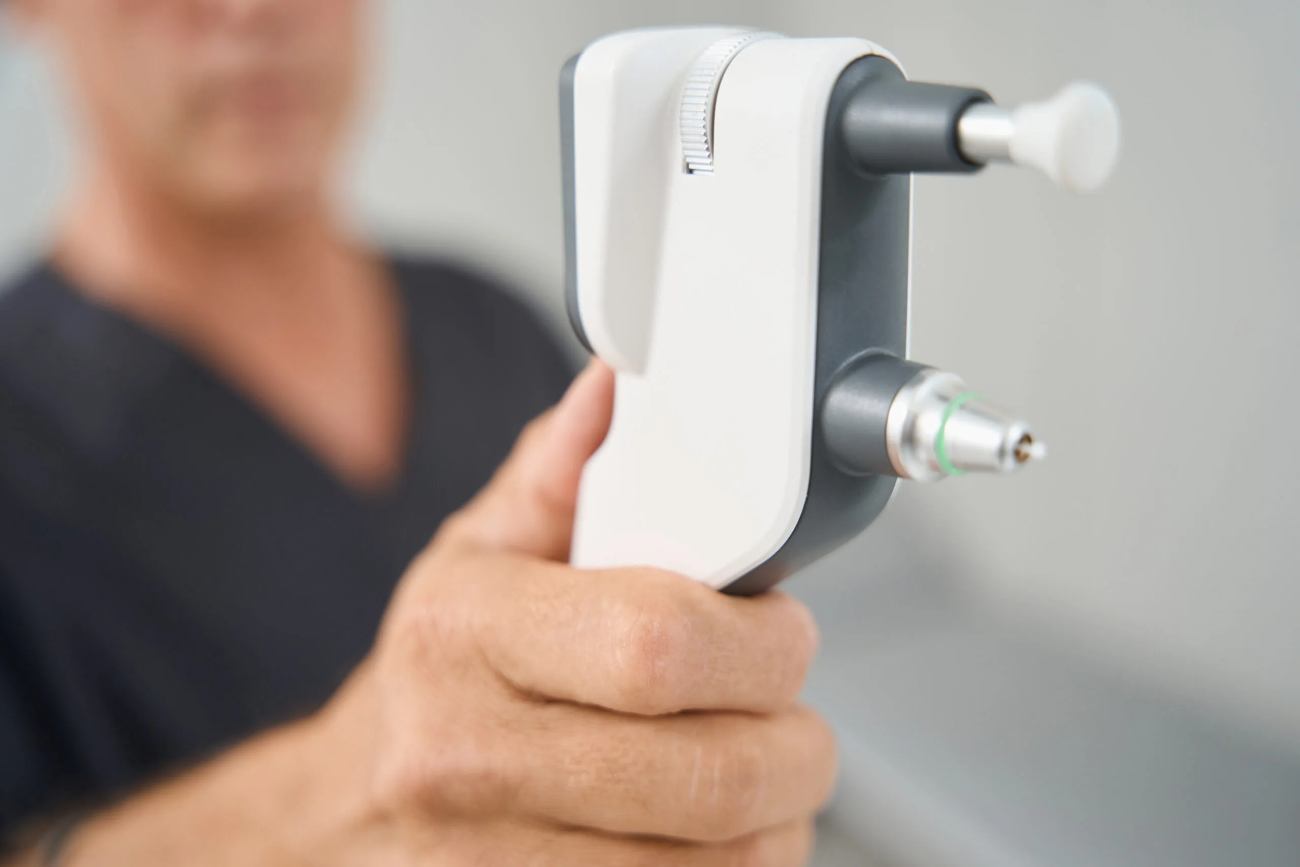 Close up photo of medical worker holding tonometer tonometer